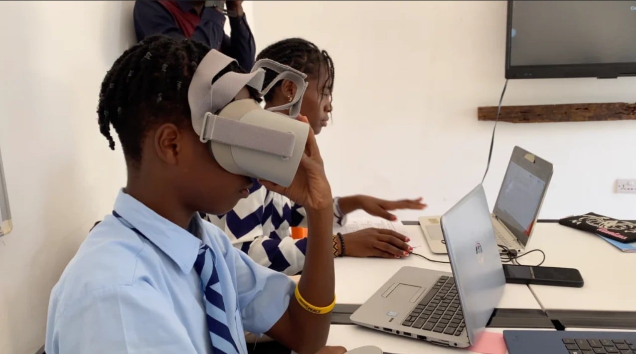 A student exploring virtual reality alongside a laptop
